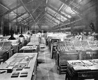 view M0003207: Lighting and desks in inspection room of large printing works / M0003207EB: Three women working on adjustable chairs