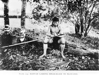 view M0005516: A Kenyah man attaching a spear blade to a blowpipe, Borneo