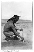 view M0005700: Hopi man performing a ceremonial corn planting ritual