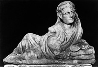 view M0004954: Lid of an Etruscan carved to show an aruspice (haruspex) lying down holding a liver in his left hand