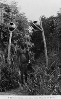 view M0005522: Man standing beneath a structure erected to ensure good health to twins, Bopoto, Congo