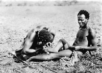 view M0005301: Extracting a thorn from the sole of a man's foot, Southern Africa