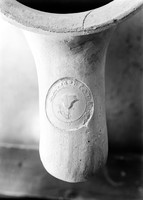 view M0005489: Seal on a large, white amphora with pointed base, long neck and two handles bearing seals, Cyprus, 5-4th century B.C.