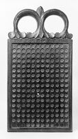 view M0011889: Photograph of a wooden board with a carved handle at the top used for stamping out lozenges in the 18th century