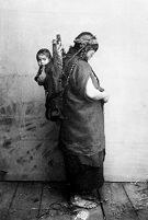 view M0013695: Mapuche child being carried on a woman's back in a carrying cradle, Chile