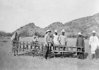 view M0013047: Mr Barrett with group of men and photography ladder, Jebel Moya