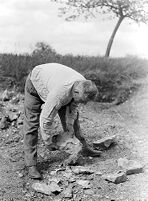 view M0015975: Leon Coutier's anvil technique: striking off flakes and shaping piece of stone