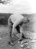 view M0015976: Leon Coutier's anvil technique: striking off flakes and shaping piece of stone