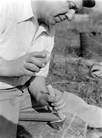 view M0015966: Leon Coutier demonstrating the production of blades by the use of the hammer and punch method