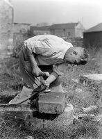 view M0015969: Leon Coutier demonstrating the production of blades by the use of the hammer and punch method