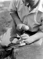 view M0015970: Leon Coutier demonstrating the production of blades by the use of the hammer and punch method