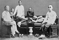 view M0017807: Photograph of men with opium smoking equipment