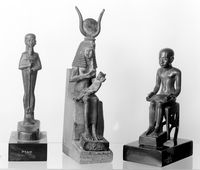 view M0017650: Three statues of Ancient Egyptian deities: Ptah, Isis nursing Horus and Imhotep