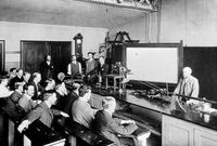 view M0020237: Photograph of William Bayliss performing a vivisection experiment on a dog in front of medical students, Department of Physiology, University College London, 1903
